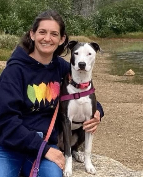 Jess with Rei beside a mountain lake